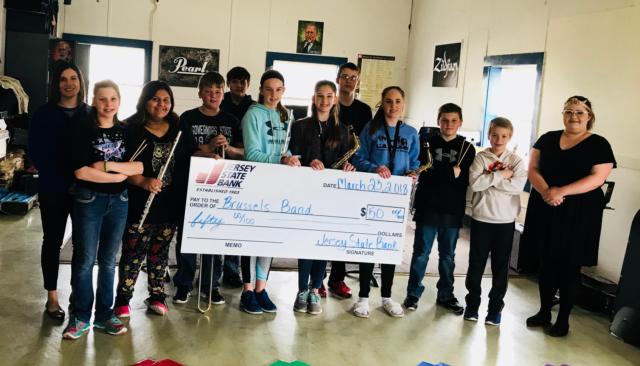 The Brussels High School band displays their $50 check after coming in third.