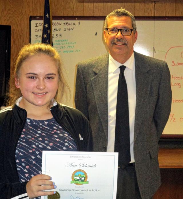 Supervisor Frank Miles presents a certificate and prize to the winner of the Township in Action essay contest: Ann Schmidt.
