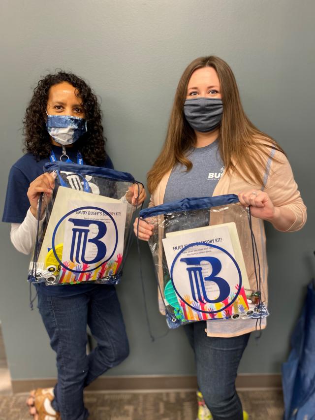 Associates at Busey Bank&rsquo;s Exec Center in Champaign compiling Sensory Kits for distribution to banking centers.
