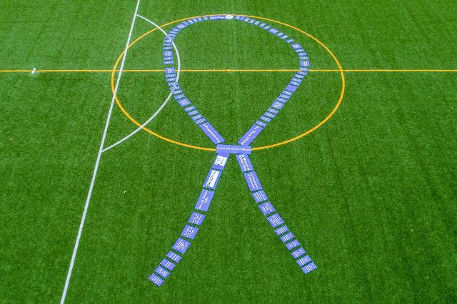  The Foundation staff laid the ribbons end to end on a turf soccer field at Godfrey’s Glazebrook Park on Friday, March 25. A drone captured this photo of the giant purple ribbon, symbolizing the community’s commitment to supporting patients undergoing treatment for cancer.