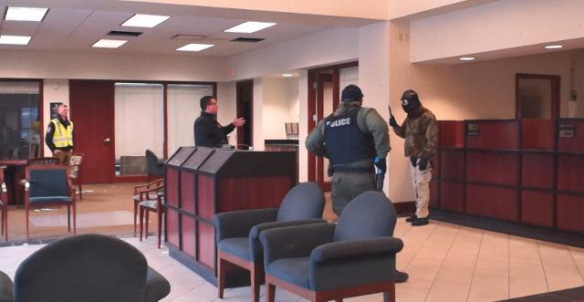Lt. Wayne White plays role of suspect with knife Sgt. Jeff Blind and Officer Jeremy Coppotelli use communication skills to talk suspect down Detective Ross Tyler is instructor and observer of training.