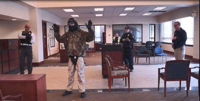 Lt. Wayne White plays role of suspect who is irate customer at bank .Sgt. Greg Boyer, Officer Gerard Spratt, and Detective Chris Johnson use de-escalation and communication techniques to calm the suspect down Sgt. Justin Click provides instruction and observation to tactics.