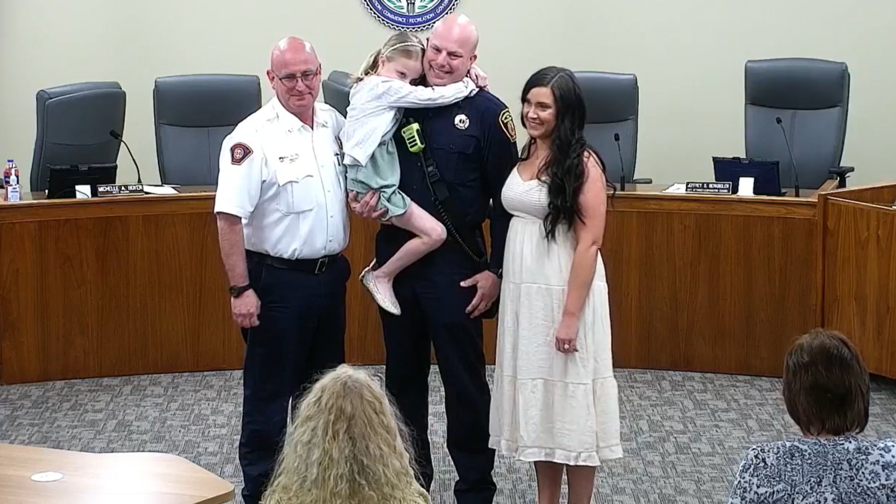 Edwardsville Fire Lieutenant Cole Schrage with Fire Chief Brendan McKee and family.