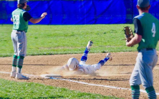 Auburn's Destin Chance slides safely into third base against the Carrollton Hawks in a non-conference game at Veterans Park in Auburn.