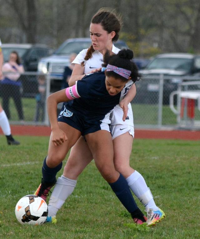 MaKayla Cox battles Belleville East's Annie Brown for the ball Monday. (Photo by Dan Brannan)