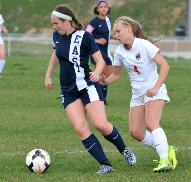 Alton's Summer Schleeper, No. 4, moves in for the ball against Belleville Monday night. (Photo by Dan Brannan)