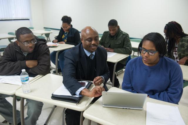 SIUE’s Shadrack Msengi, PhD, associate professor of clinical literacy in the SEHHB Department of Teaching and Learning, worked with Belleville East’s Lauren Evans (front right) and other ACT-SO participants during an enrichment session.