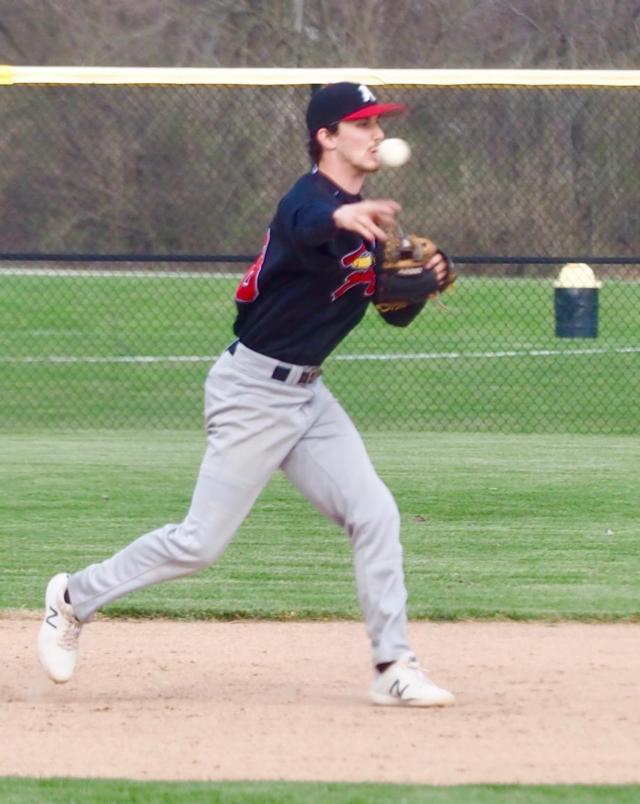Charlie Erler at second base throws out a runner going to first.