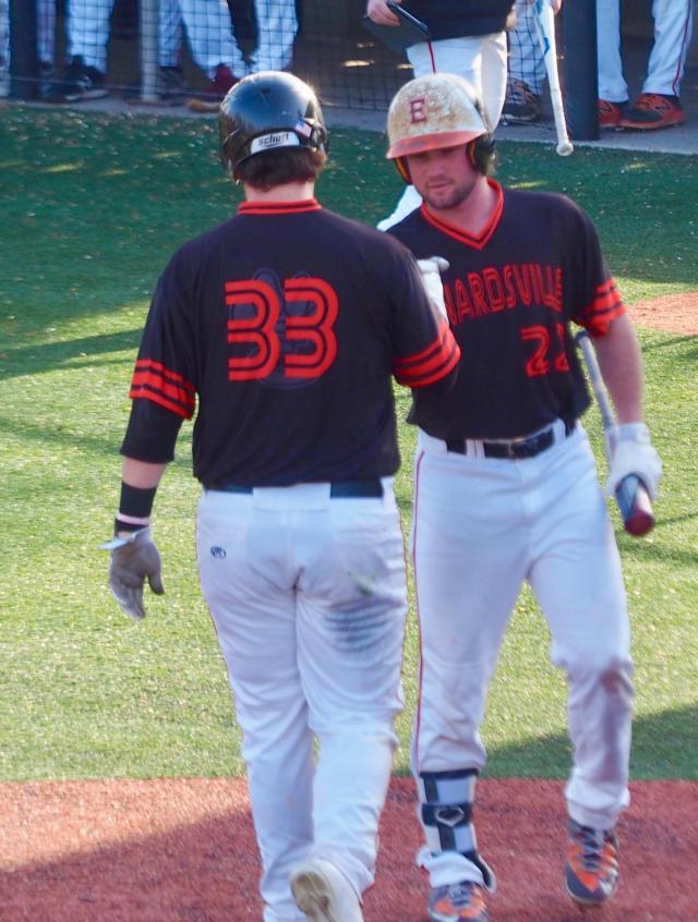 Drake Wescott (33) is greeted by Collin Elvers (22) after scoring a run.