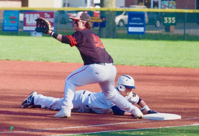 Hayden Juenger slides back to first base before Drake Wescott can apply the tag.