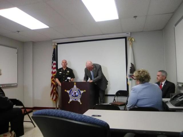 Sheriff John Lakin signing the proclamation officially establishing the Triad program in Madison County