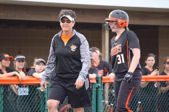 Coach Lori Blade speaks with Allisoh Loehr before her at bat.