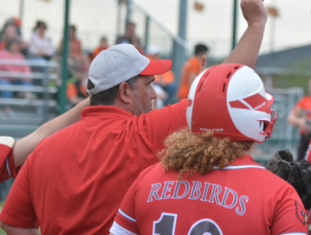 Coach Dan Carter talks with his team during a huddle. 