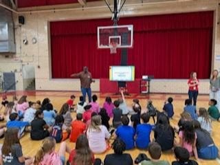 Joel Hall talks to students at West Elementary School.