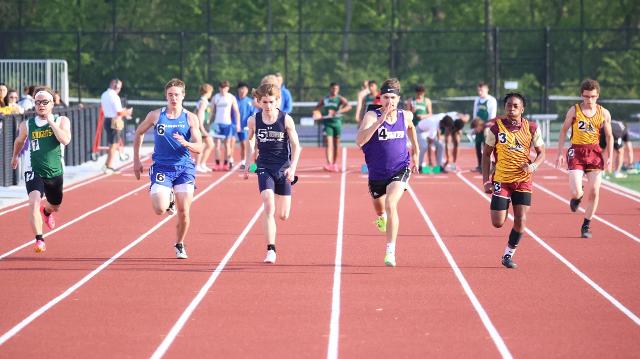 Area runners dart toward the finish line in the first heat of the 100m dash Monday afternoon at Civic Memorial's Hauser Field. 