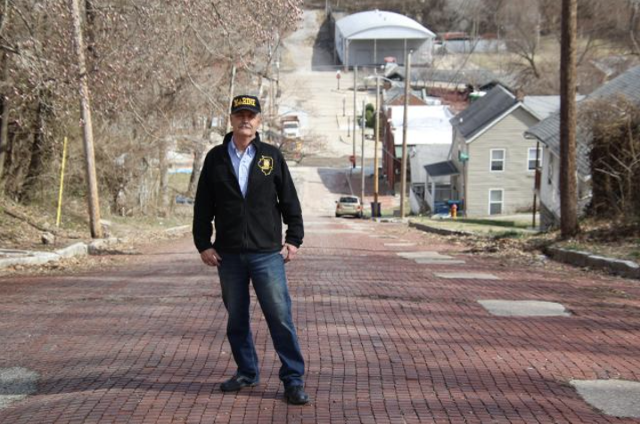 William Perkins stands on what he says he has discovered is the steepest brick street in the world.