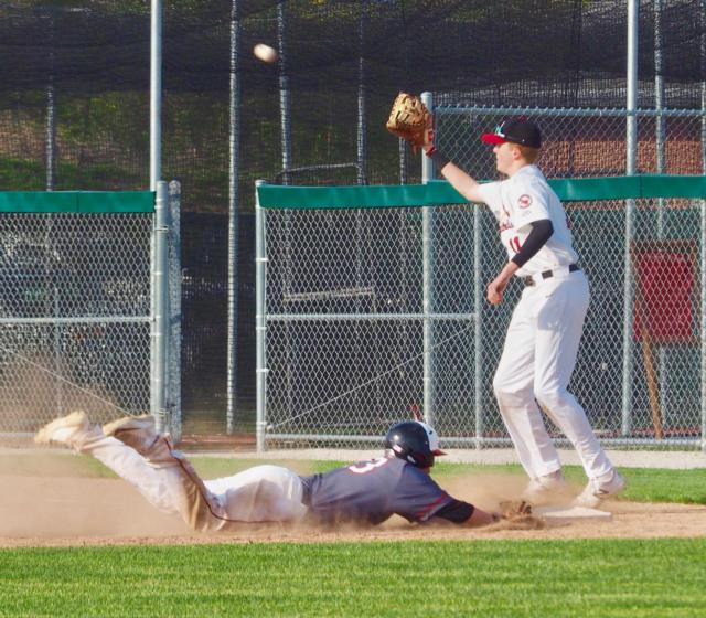 Drake Wescott slides into first base beating out a throw from center field.