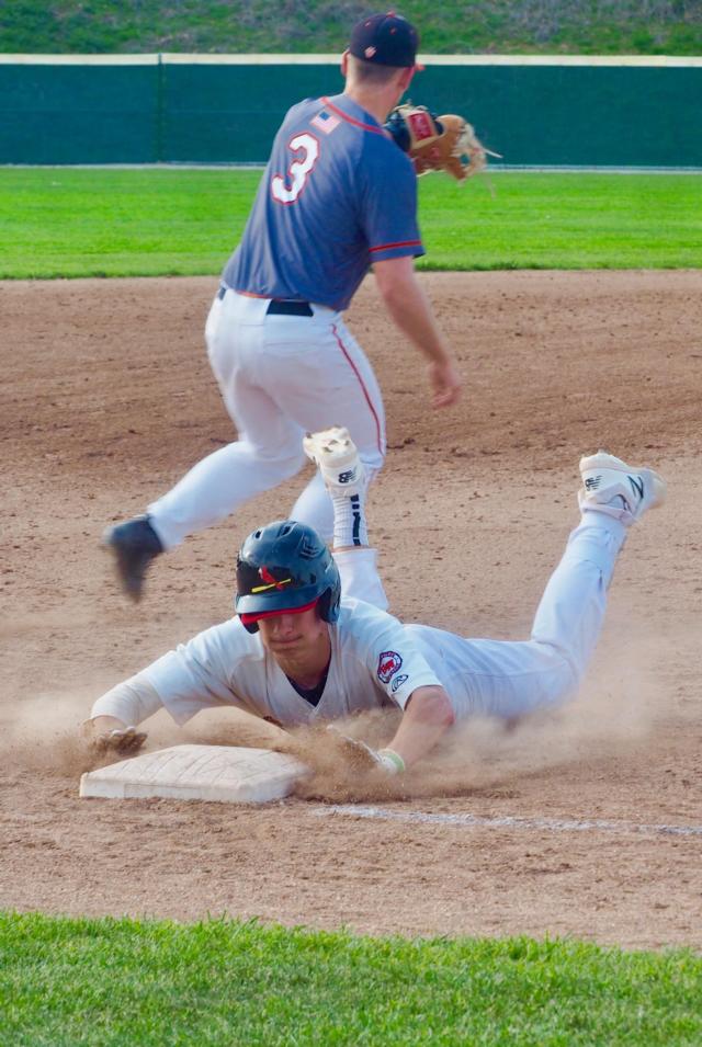 Alton's Robby Taul slides safely into third base.