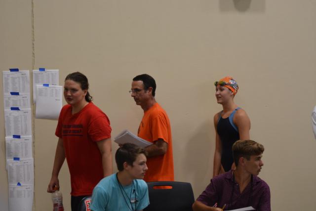 Coach Bob Rettle directing on the pool deck. (Photo by Dan Brannan)