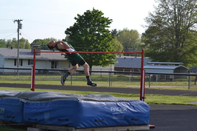 Cody Leonard goes over the bar at 6-2 in the high jump on Monday night. (Photo by Dan Brannan)