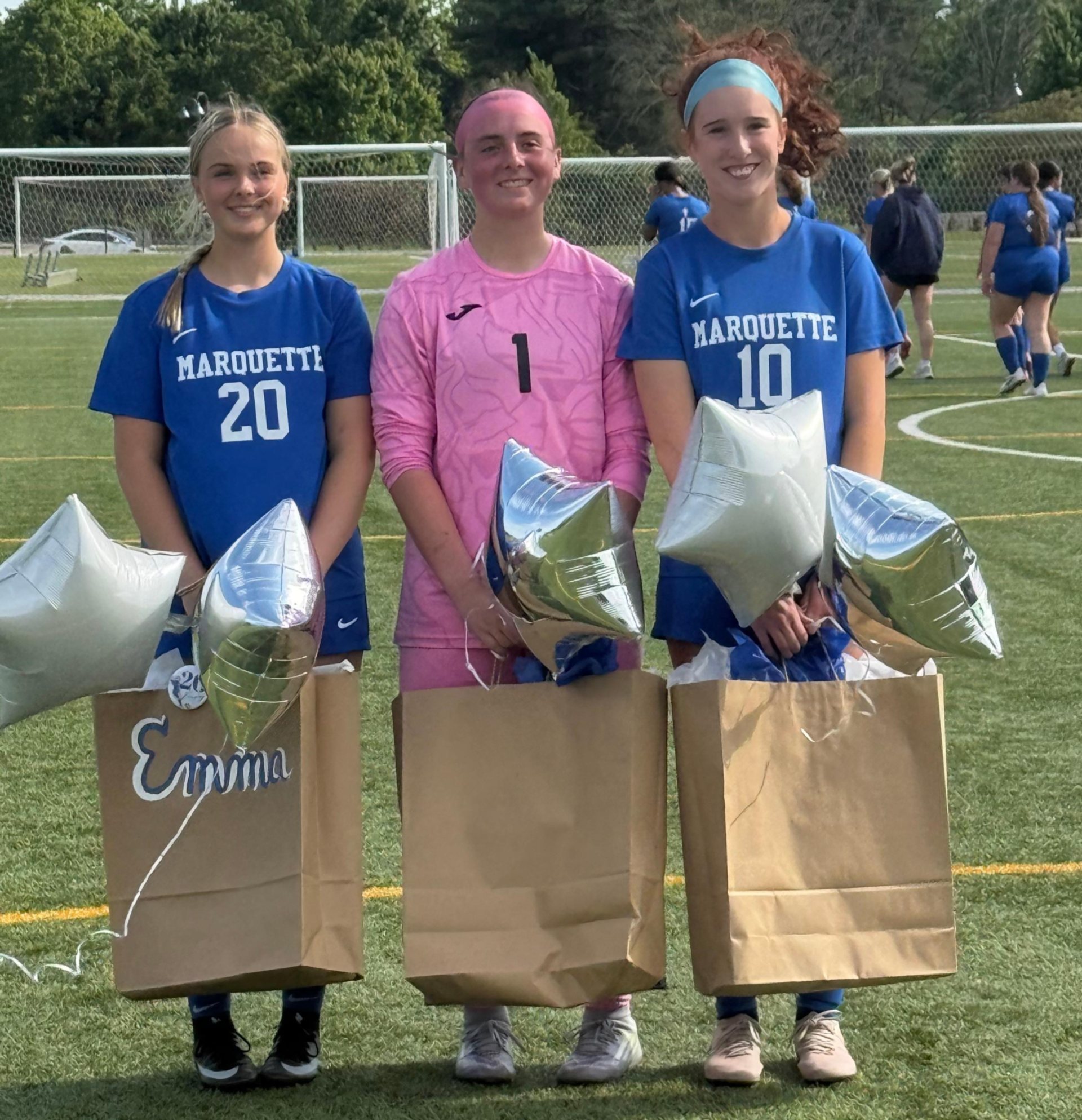 From left, Marquette Catholic seniors Emma Dempsey, Jessica Eales and Maddie Waters.