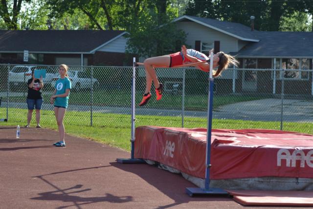 Alton's Katie Mans is shown trying to move to the 5-6 mark in the high jump, her personal best. (Photo by Dan Brannan)