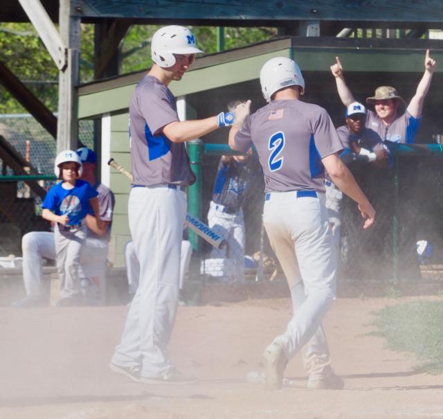 Montana Gossage greats Jayce Maag after Maag scores off a sacrifice fly in the first inning.