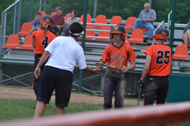 Edwardsville coach Lori Blade praises No. 2 Megan Radae after a clutch hit late in the game against Belleville West on Thursday. Radae was a perfect three for three hitting in the contest. (Photo by Dan Brannan)