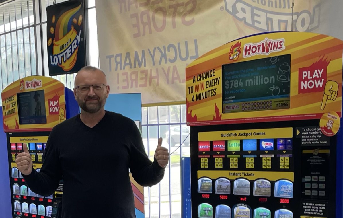 John, store manager at Lucky Mart in Chicago, celebrates with two thumbs up after selling a $1 million winning Lotto ticket.