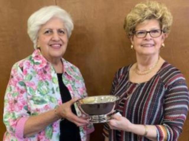 Pictured is Janet Hansen (left) presenting the Silver Bowl to Nancy Johnson (right).