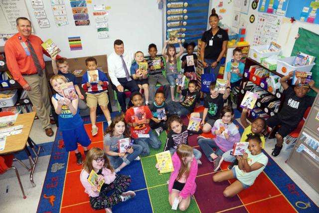 With the students are, left to right, Rusty Ingram, director of Business Development at AMH; AMH President Dave Braasch, who read some of the books to the students on Thursday; and India Chapman of BJC School Outreach and Youth Development.