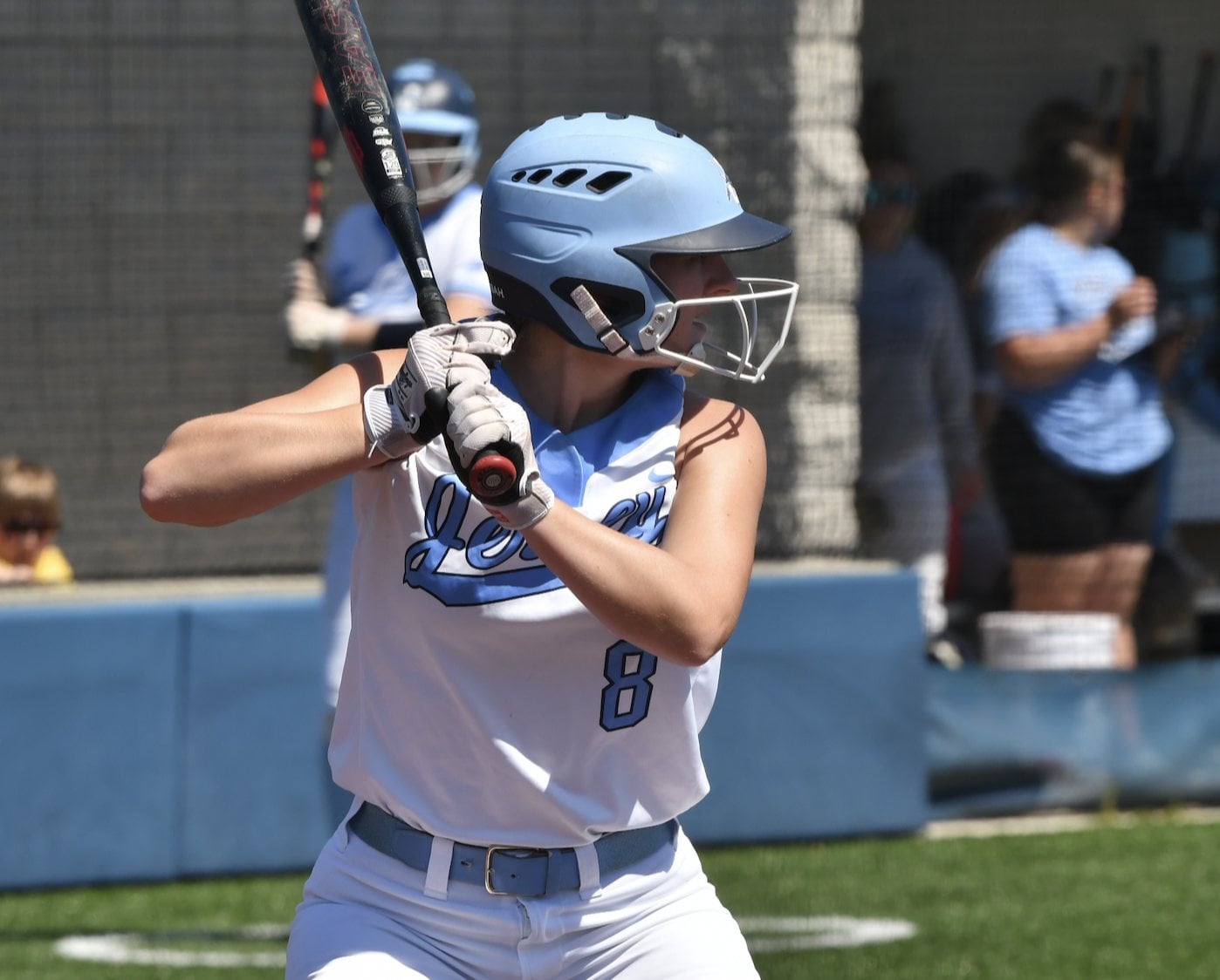 Anna Kribs at the plate and out in the field in the photos (top and bottom). Photos by Dan Brannan).