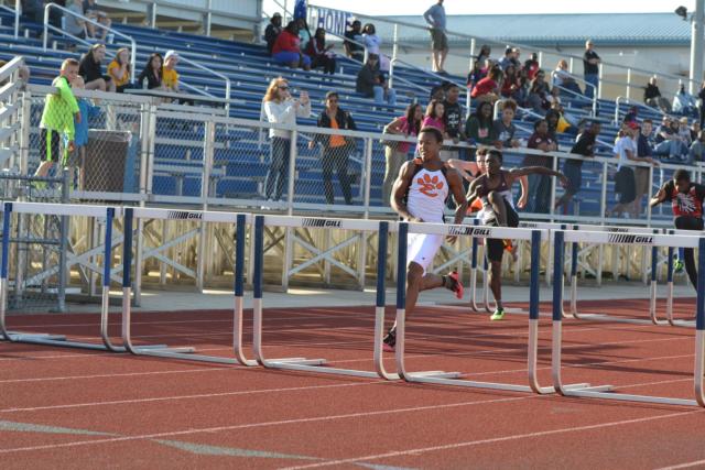 Edwardsville's Travis Anderson glides to an easy first place in the conference 110-meter high hurdles on Wednesday. (Photo by Dan Brannan)