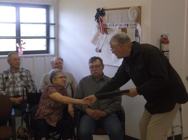 Illinois Senator William Haine (D-Alton) presents a plaque on behalf of the Township Officials of Illinois to Laubscher