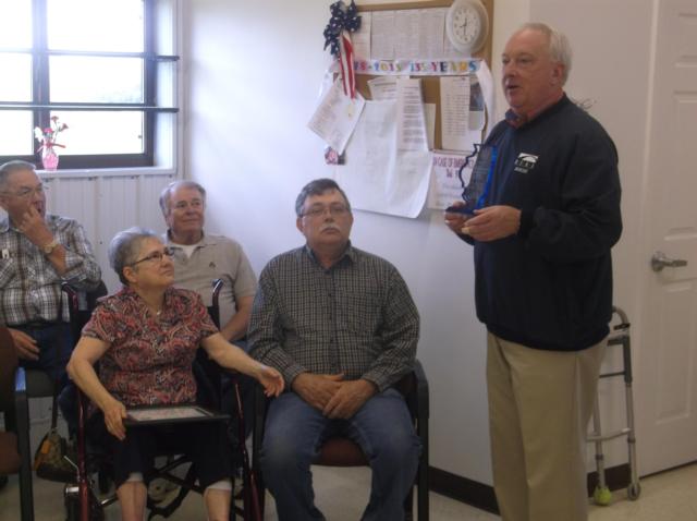 Rep. Dan Beiser (D-Alton) presents an award to outgoing Elsah Township Clerk Janet Laubscher on behalf of the Elsah Township Board