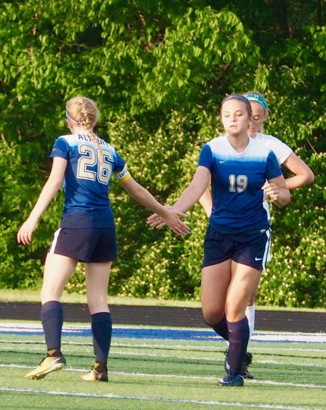 Liesl Whitener high-fives Madison Eghigian after scoring her first goal.