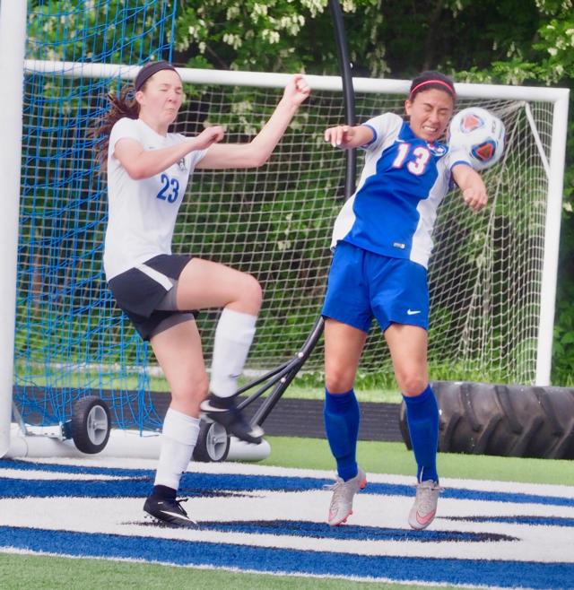 Brynn Huddleston (13) wins a header between Sophia Bonaldi.