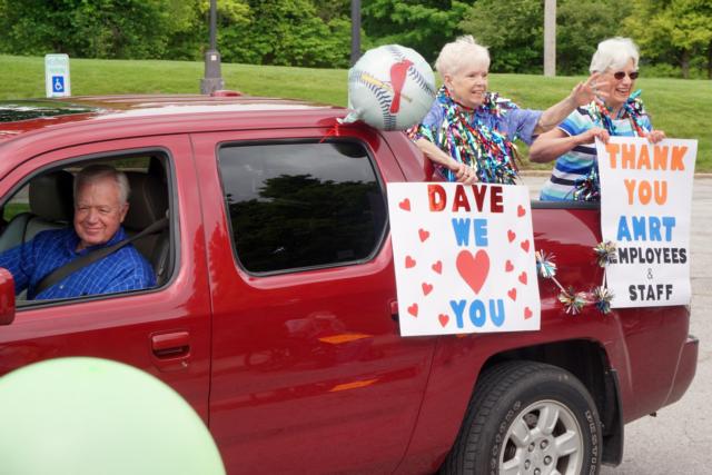 Ann Larson (left) and Rita Cooke hold up signs for the residents of Alton Memorial Rehabilitation and Therapy (the former Eunice Smith Home) during a parade Friday.