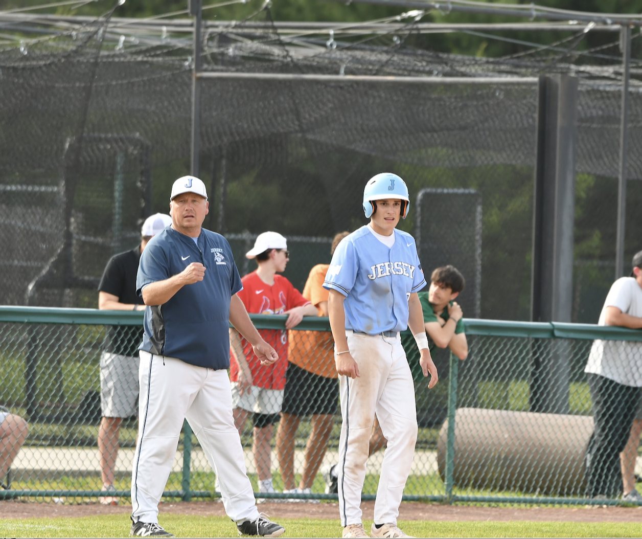 Jersey Coach Darren Perdun, left, encourages his players on the field.