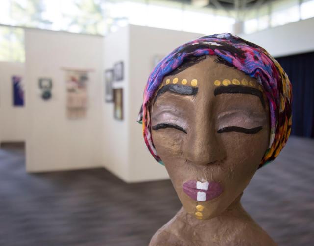 A papier mache/mixed media piece entitled “For My People,” by Taija Cook, a senior at Edwardsville High School, is featured in the Lewis and Clark Community College 2017 Regional High School Art Exhibition in L&C’s Ahlemeyer Atrium. Photo by Laura Inlow, Lewis and Clark Community College