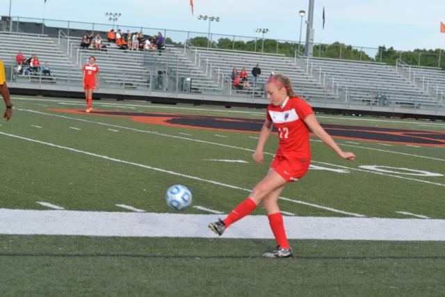 Alton's Annie Evans delivers a kick during the Granite City match. (Photo by Dan Brannan)