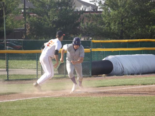 Aaron Jackson waits on a throw at third base. (Photo by Brent Feeney)