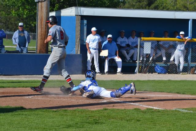 Alton's Matt Hopkins scores the winning run after Bryan Hudson's double. (Photo by Dan Brannan)