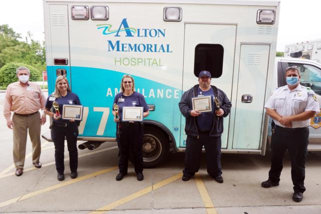Among the award winners for the past 12 months in various competitions among EMS personnel at Alton Memorial Hospital are, left to right, Layla Simons, Rose Marie Hand and Aaron Darr. In the back are AMH Vice President Brad Goacher (left) and EMS manager Jason Bowman. The competitions included placing 12-leads, moving 12-leads to the proper position and placing IVs.