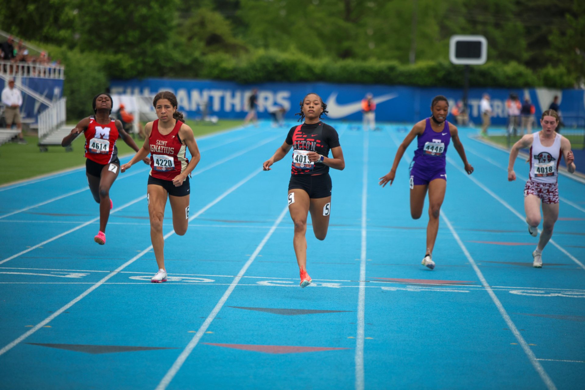 Rayna Raglin of Alton (center) led all qualifiers in the 100 meters on Friday to Saturday's finals. (Chris Rhodes photo).