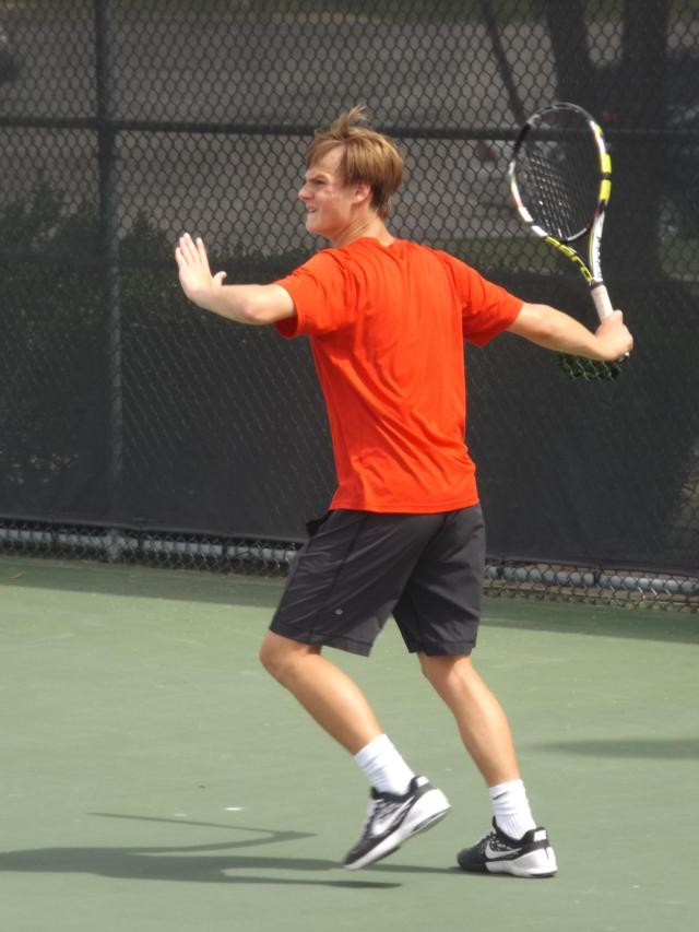 Alton's Walker Moan returns a shot during singles competition at the IHSA Alton Sectional tennis tournament at Lewis and Clark Community College in Godfrey Friday afternoon.