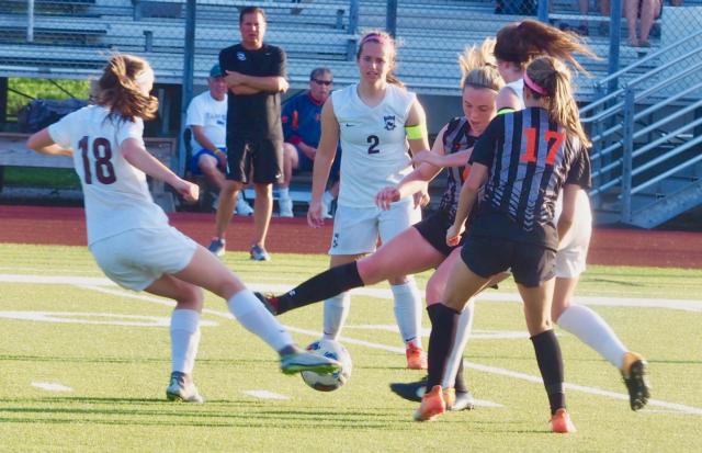 Paityn Schneider (9) and Belleville West's Lily Stedman battle for possession.
