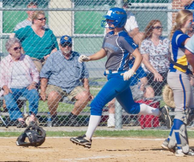 Abigail Porter scores the first run of the game for Marquette.