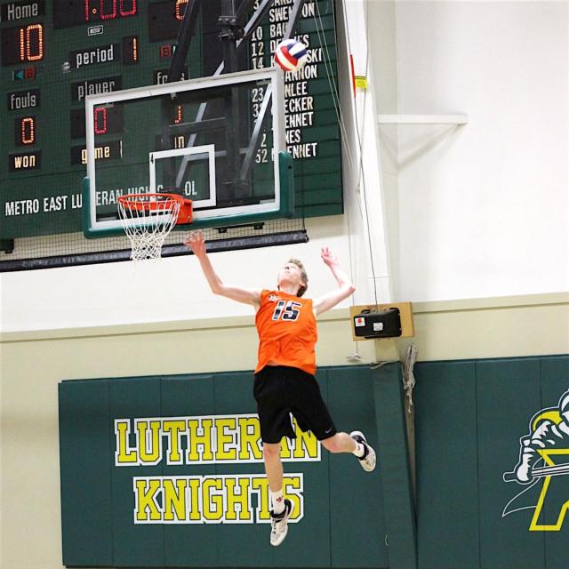 Nick Allen soars into the air as he serves for the Tigers. 