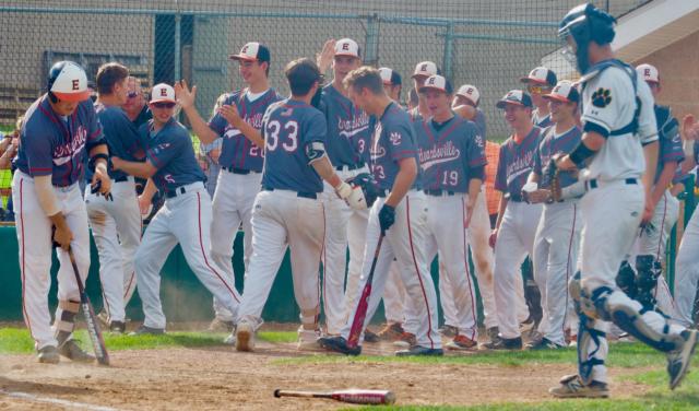 The Tigers dugout congratulates Drake Westcott after hitting a home run.
